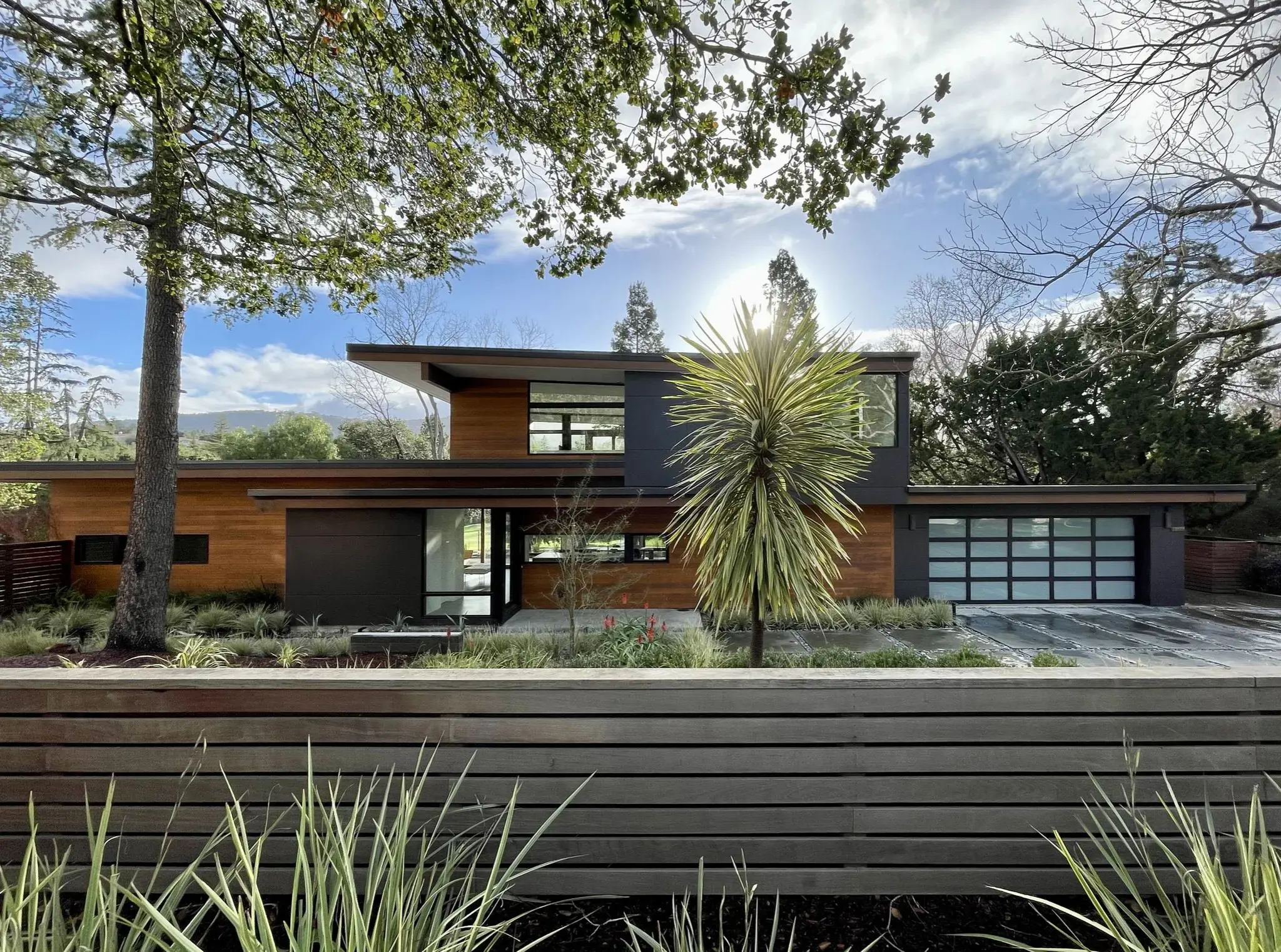 Modern bathroom renovation with wood vanity and marble countertop